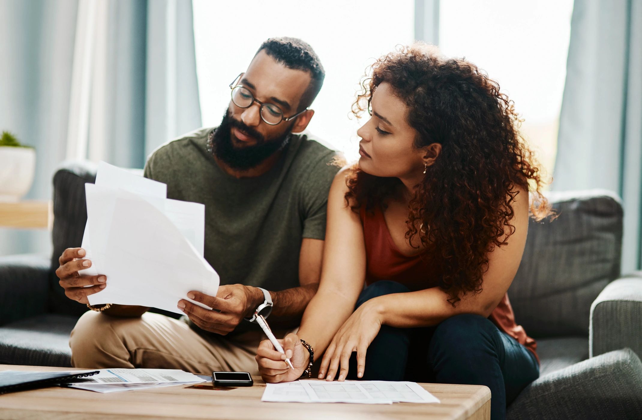 Couple reviewing financial and home documents together